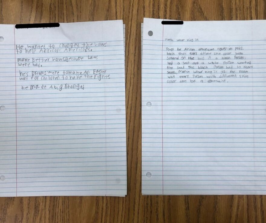 Two lined papers side by side responding to a paragraph about who Martin Luther King Jr. is. Response 1: "He wanted to change the laws to help African Americans. Make better laws. Because laws were bad. His dreams were to make an easier way for children to have the rights. He made a big change." Response 2: "Fought for African American rights in 1965. Back then every different skin color were separated. On the bus if a black person had a seat and a white person wanted the seat the black person had to move seats. Martin Luther King Jr. is the reason why every person with different skin color can be a community."