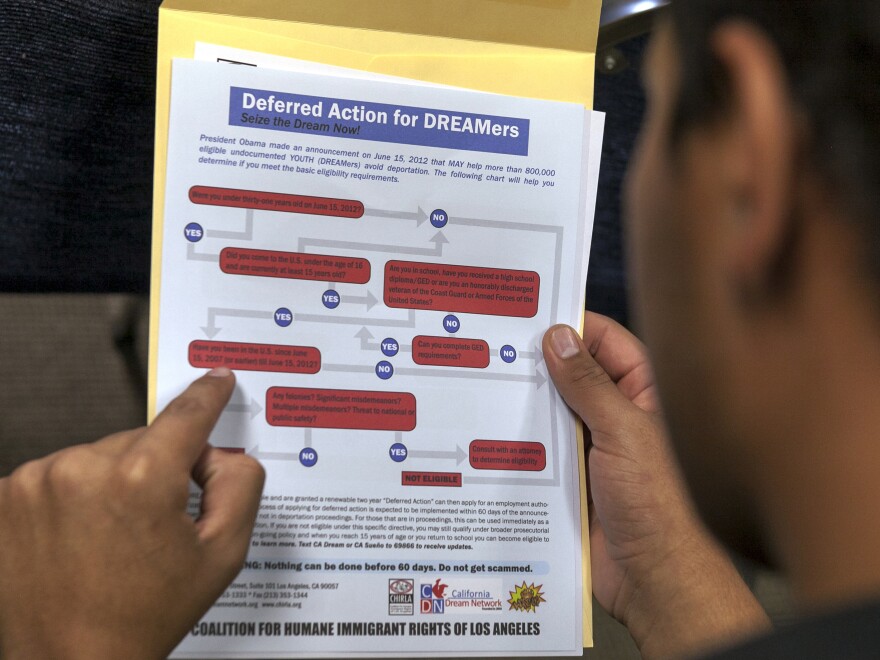 An immigrant reads a guide of the conditions needed to apply for DACA protection.