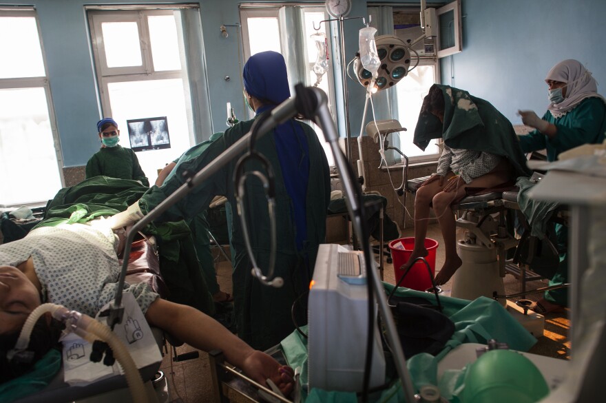 "This is a fistula repair in Kabul, Afghanistan, with two surgeries going on side by side," Addario says. "A fistula is a tear, often between the vagina and the anus. It's common in many countries with child marriage, or where women have birth very young. It's quite a shame — often women are shunned from their houses or don't get care — there's often a smell associated with fistula."