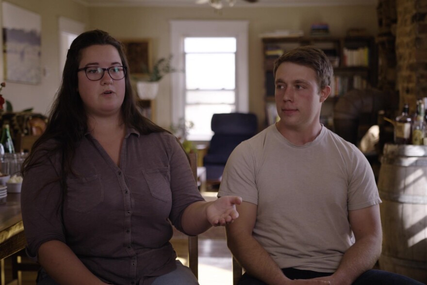 Jessie Linton and Shane Murrow are sitting in their kitchen.