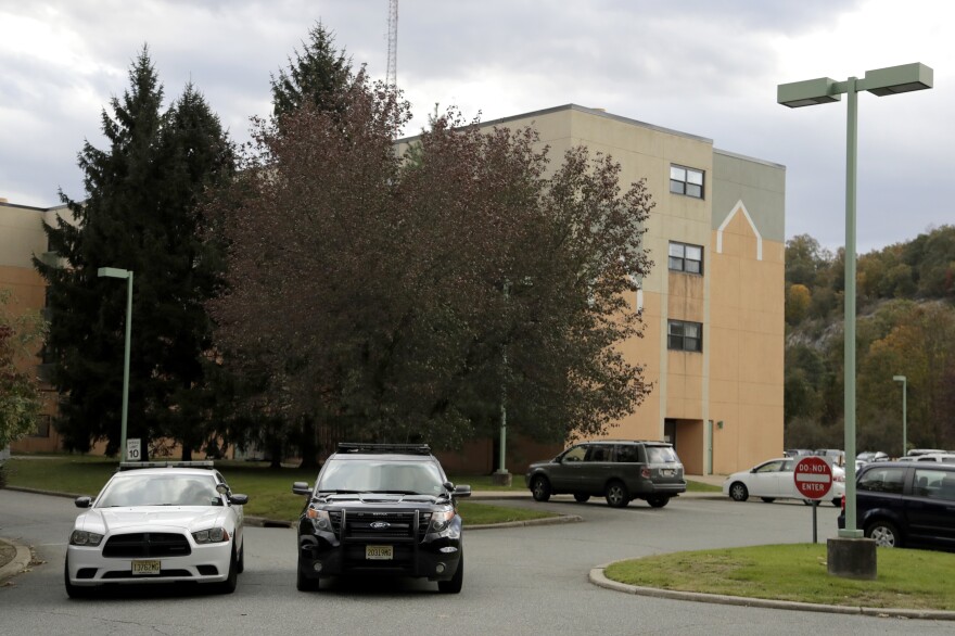 Police cruisers are parked near the entrance of the Wanaque Center for Nursing And Rehabilitation in Haskell, N.J., where the New Jersey Department of Health confirmed cases of adenovirus in October 2018. Dozens fell ill from the outbreak, and 11 died.