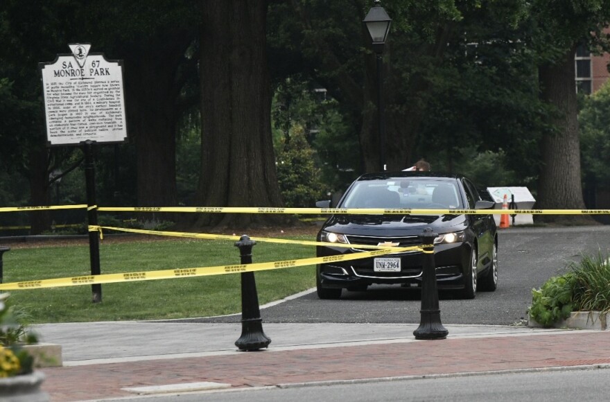 police tape between bollards and the Monroe Park historic marker