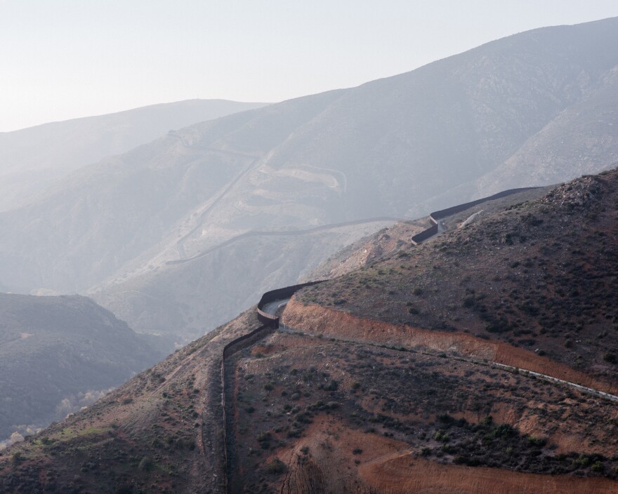 A view of the U.S.-Mexico border fence as it winds through the rugged San Ysidro Mountains southeast of San Diego. The administration is calling for 5 more miles of new barrier in this area.