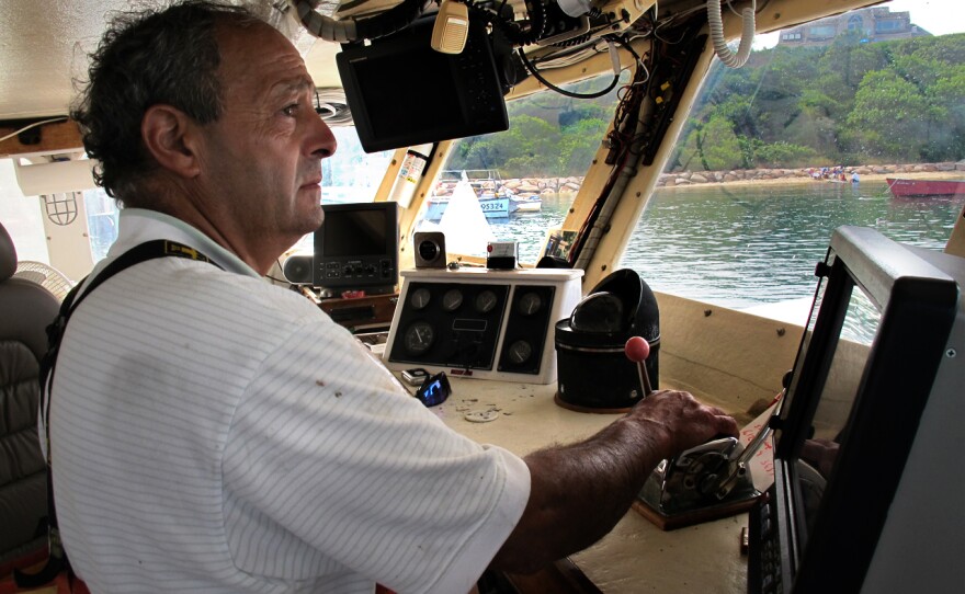 Boat captain Bill Amaru pilots his trawler, the Joanne-A III, to its mooring in Chatham Harbor on Cape Cod after a cod fishing trip.