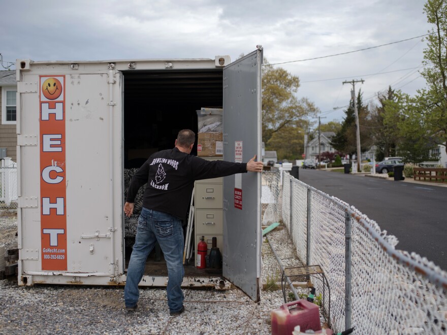 Doug Quinn closes his storage container, on the empty lot of his home destroyed by Superstorm Sandy.