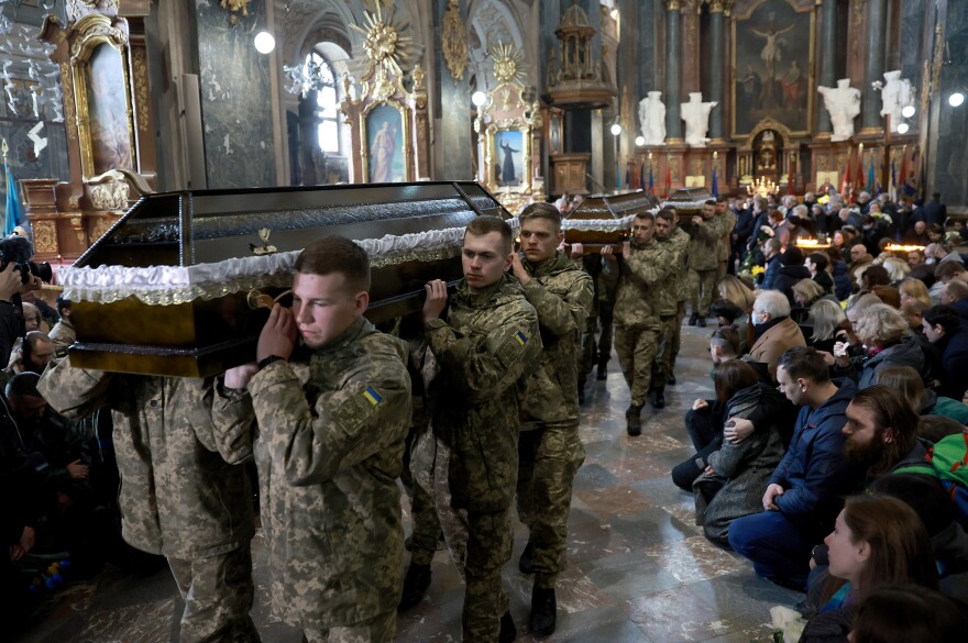 <strong>March 31:</strong> Ukrainian military members carry the caskets of three Ukrainian servicemen from the Church of the Most Holy Apostles Peter and Paul during their funerals in Lviv.
