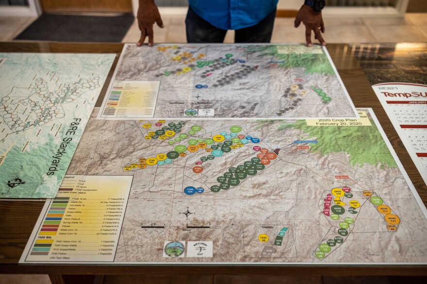 Simon Martinez, ranch manager, shows a map of planted fields from 2020 and 2021 at Ute Mountain Ute Farm and Ranch. The farm used only 8 of their 110 fields in 2021. By contrast, in 2020 it used 109 of 110.