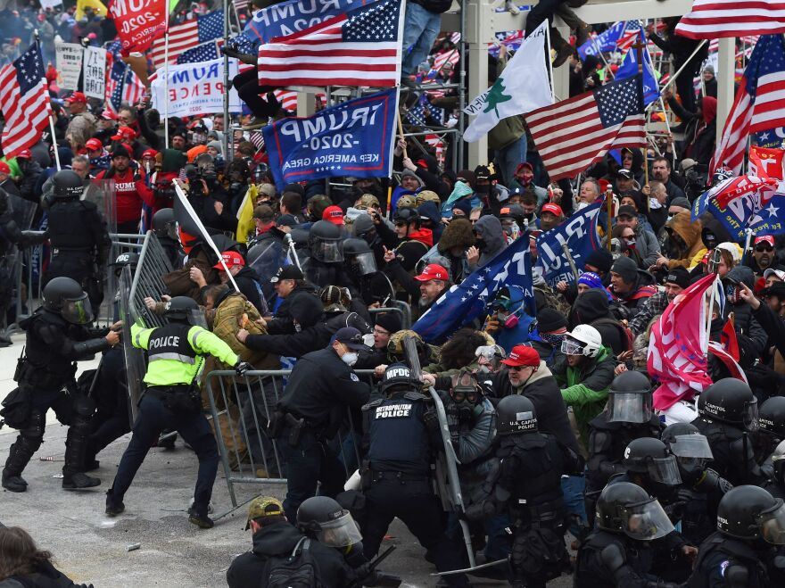 Trump supporters clash with police and security forces as they push barricades to storm the Capitol on Jan. 6, 2021.
