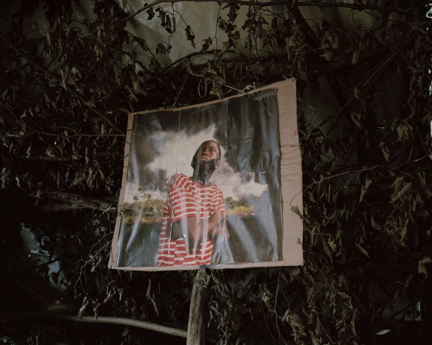 In their forest community, the activists display an altered image from Nigerian photojournalist George Osodi and his work highlighting multinational oil companies and their role in degrading the ecosystem.