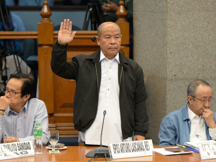 Retired police officer Arturo Lascañas takes his oath during a Senate hearing in Manila on March 6, 2017. The former police aide of Philippine President Rodrigo Duterte said he was part of a "death squad" that took part in hundreds of killings when Duterte was a city mayor.