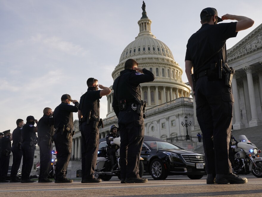 U.S. Capitol Police officers salute as the casket of slain officer William "Billy" Evans leaves the Capitol in a hearse after he was lying in honor on April 13.