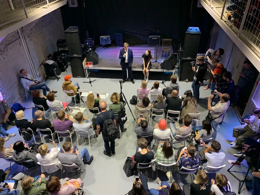 Ilya Novikov, Zhukov's lawyer, speaks at an auction to support political prisoners. Novikov says that even though the charges against Zhukov have changed and he's now under house arrest, the student still faces up to five years in prison.