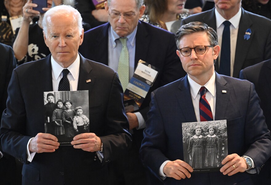 President Biden and House Speaker Mike Johnson hold images of Holocaust victims during the annual Days of Remembrance ceremony at the U.S. Capitol.
