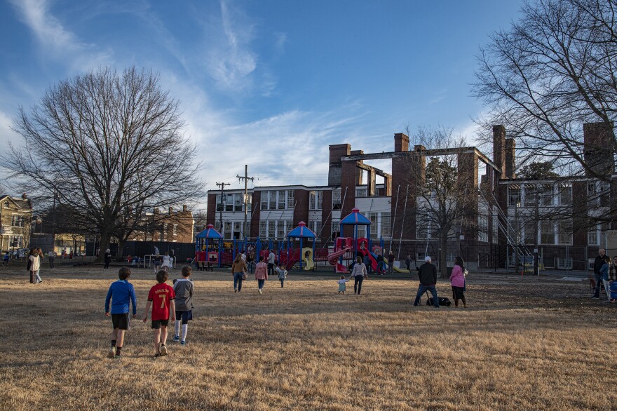 People gather around a playground
