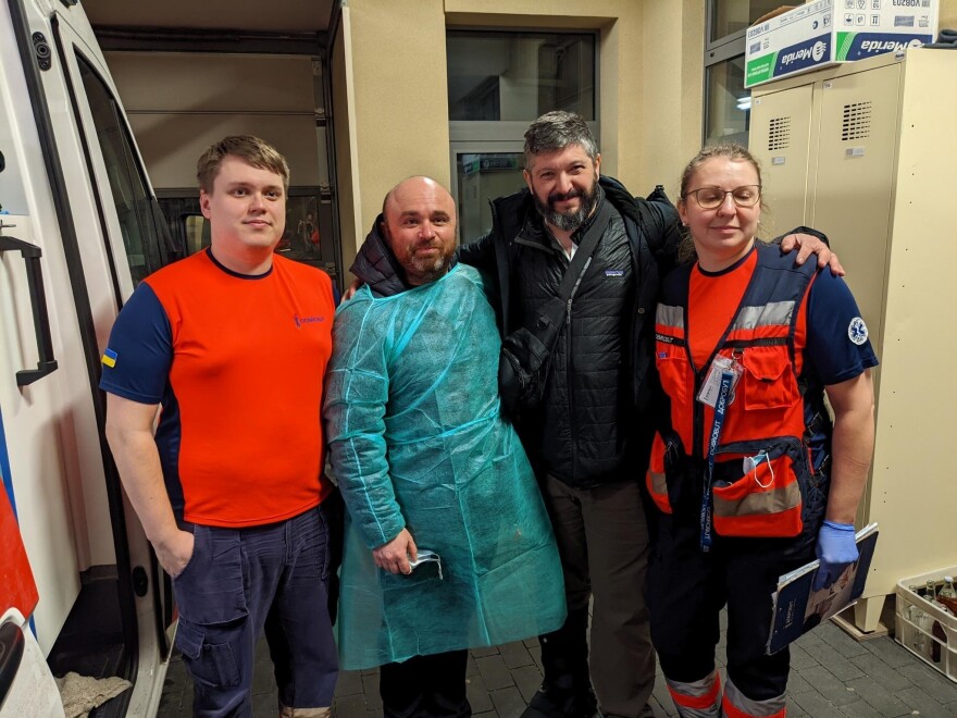 Spektor (second from left) and Stern (second from right) stand with staff who helped transport twins Lenny and Moishe.