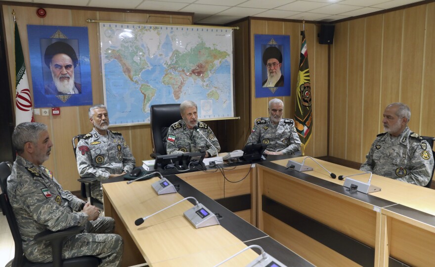 Iranian military personnel placing a message on a ballistic missile
