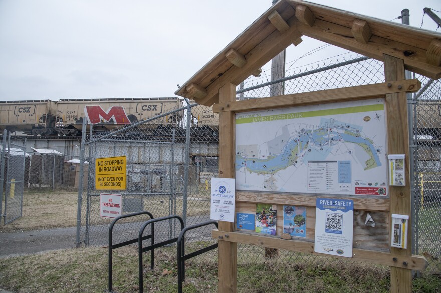 fenced off section of James River Park for sewage; signs include "no stopping in roadway, not even for 30 seconds" and "no trespassing; city of richmond"