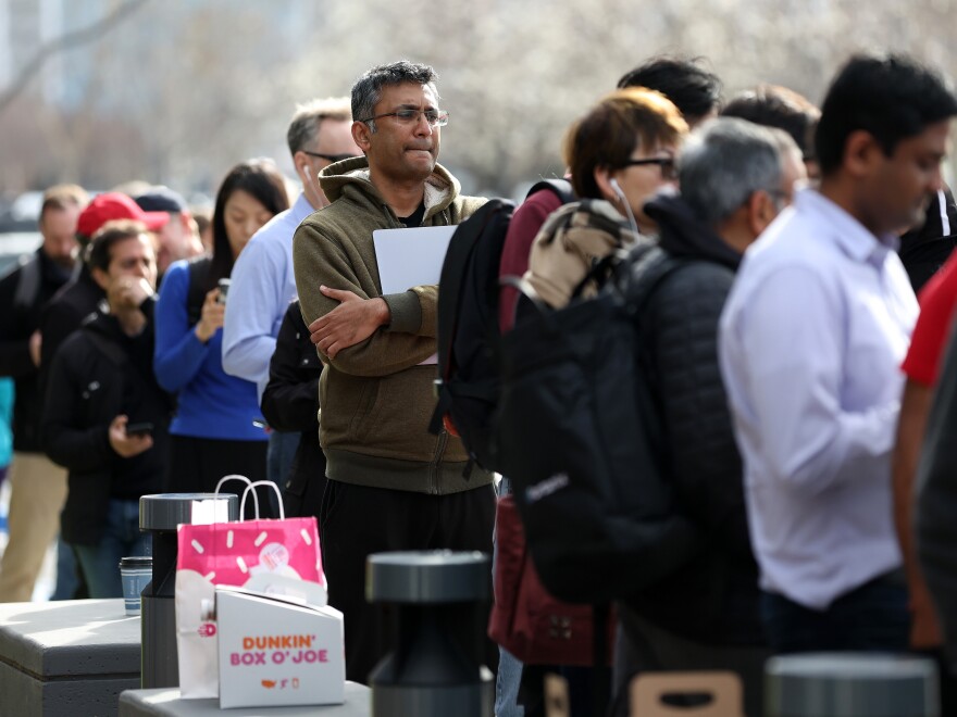 People line up outside of a Silicon Valley Bank office to try to collect their money on Monday after SVB's collapse.