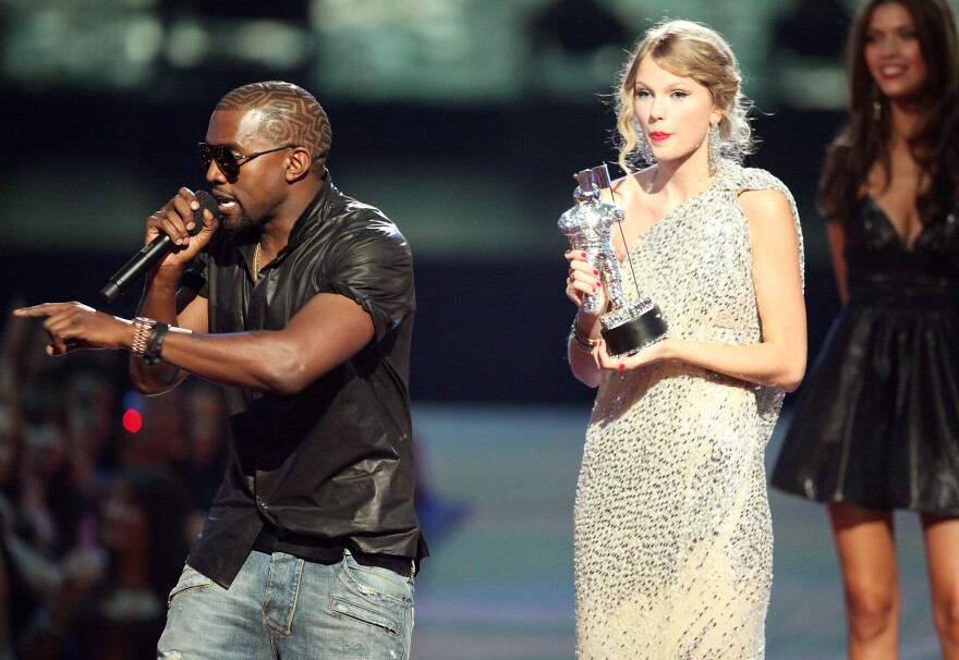 Kanye West rushes the stage as Taylor Swift accepts the "Best Female Video" award during the 2009 MTV Video Music Awards on Sept. 13, 2009.