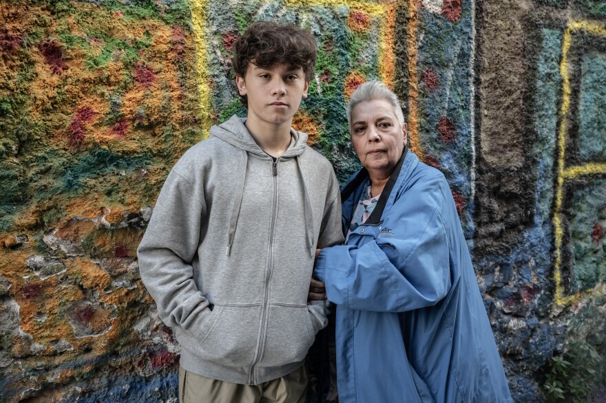Stella Belia (right), a member of the Rainbow Families of Greece, an organization that focuses on LGBTQ parents, poses for a portrait with one of five children, Yannis, in Athens, on Jan. 30. Greek lawmakers are set to vote on a bill legalizing same-sex marriage and adoption this week.