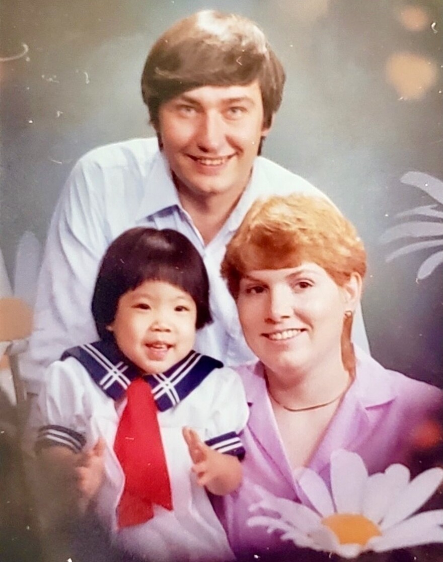 Nicole Chung, left, smiles with her parents in Oregon in the 1980s.