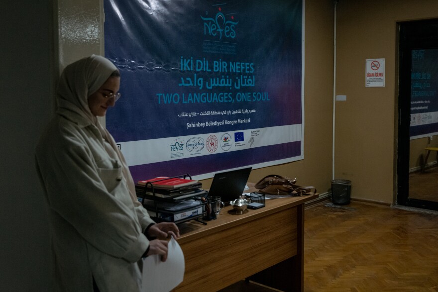 A banner at the front of the Nefes Music School reads "Two Languages, One Soul."