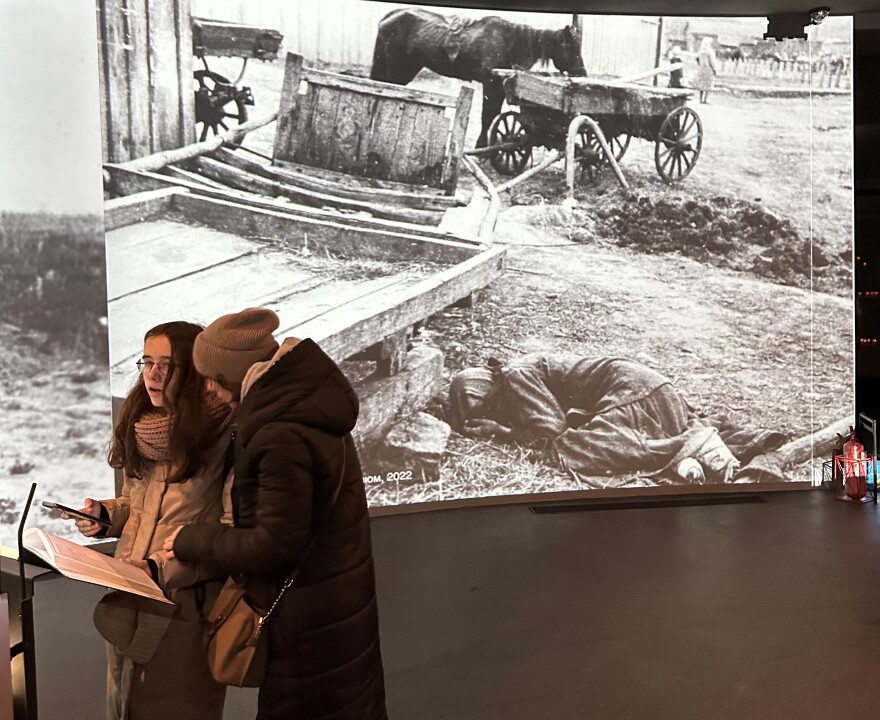 Ukraine last month marked the 90th anniversary of a 1932-33 famine that the country blames on Soviet dictator Josef Stalin. In this photo, visitors to the National Museum of the Holodomor Genocide in Kyiv look though a book with some of the names of the 4 million or more Ukrainians who died in the famine. In the background is a photo of one of the victims of that period.