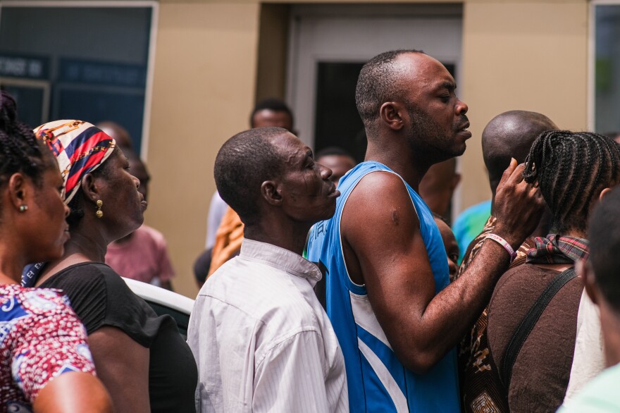 Frustrated Nigerians line up at an ATM in Lagos, trying to withdraw scarce new niara notes.