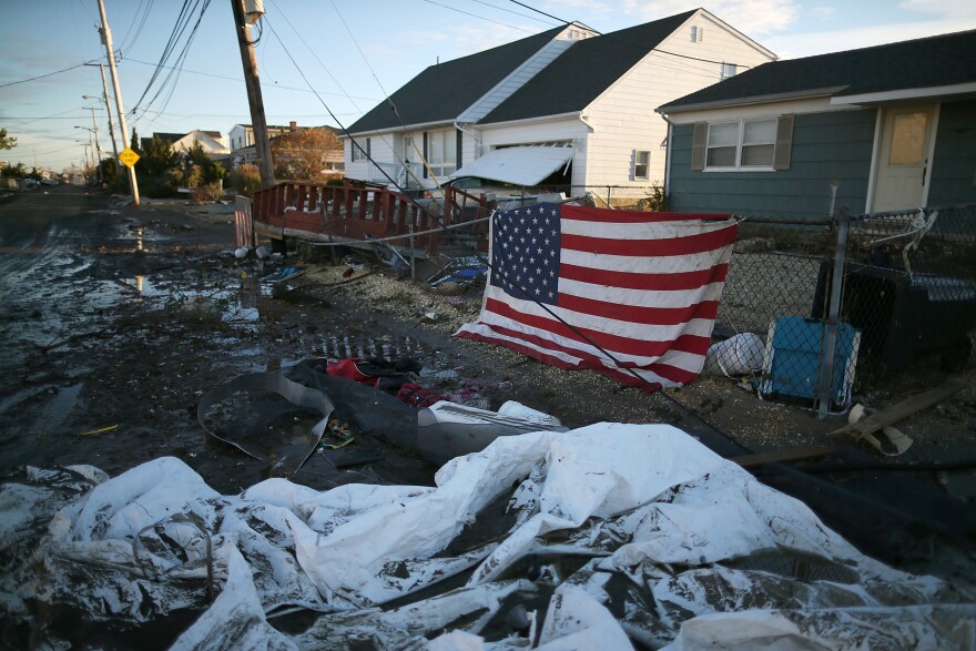An American flag flies in front of a home damaged by Superstorm Sandy on Nov. 1, 2012, in Toms River, N.J.