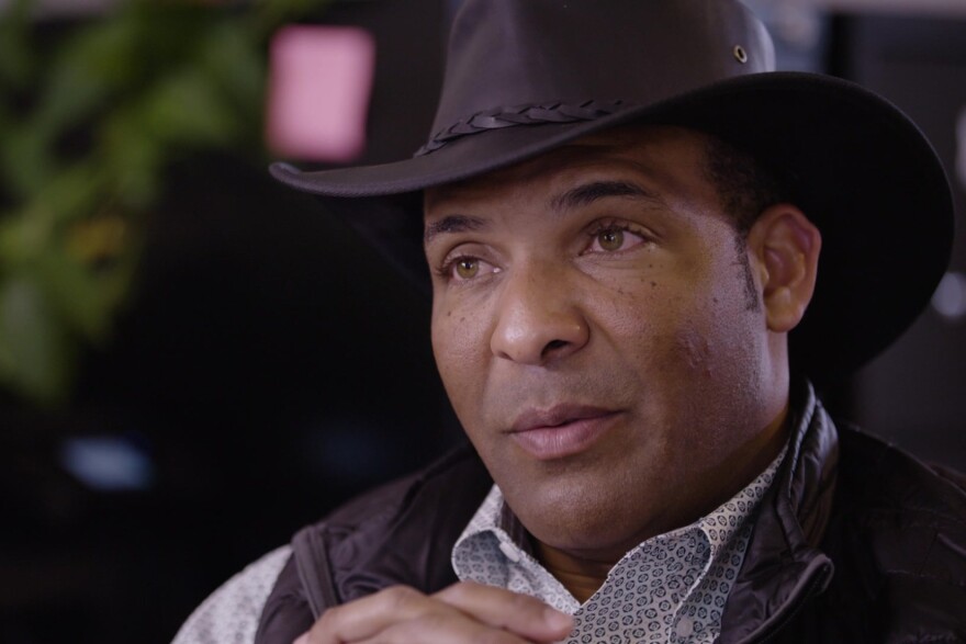 Shoulder to head shot of PJ Haynie wearing a black cowboy hat.