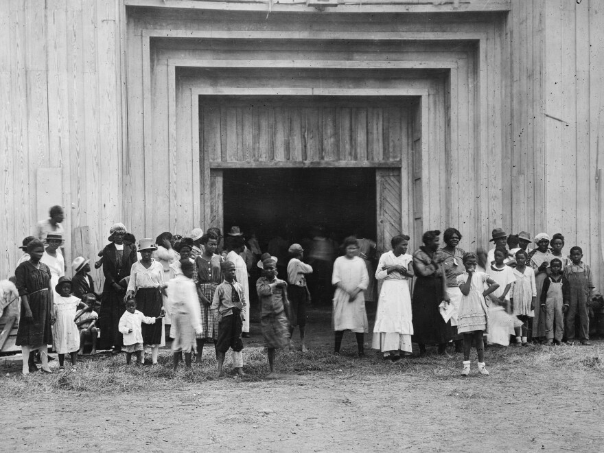 Black residents stand outside the entrance to a refugee camp on the fairgrounds in Tulsa after the massacre. Tulsa, and the nation, have been slow to acknowledge the brutal reality of what happened in 1921 and the lasting impact it's had on Black families.