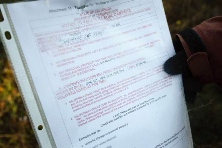 Up the hill from where Norm Ciha camps, Caltrans posts advisories about scheduled cleanups. An ongoing lawsuit claims the agency systematically seizes and destroys people's belongings, violating a constitutional right.