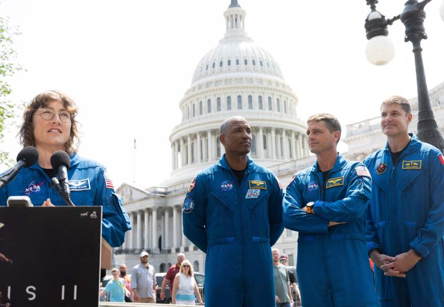 NASA Astronaut Christina Hammock Koch (L) speaks alongside fellow members of the crew of the Artemis II mission, with NASA astronauts Victor Glover (L) and Reid Wiseman (C), along with Canadian Space Agency astronaut Jeremy Hansen (R) outside the U.S. Capitol in Washington, D.C., on May 18, 2023.