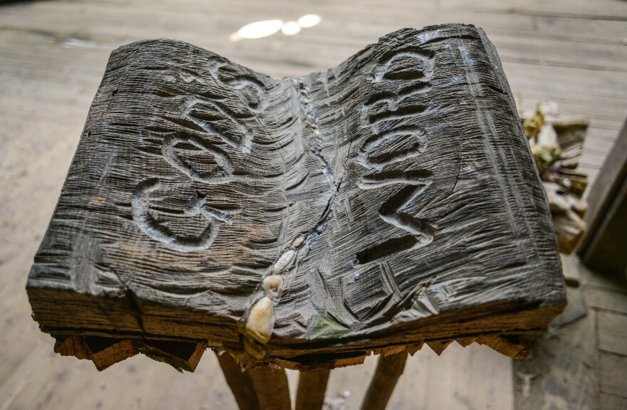 A hand-carved bible in the pulpit.