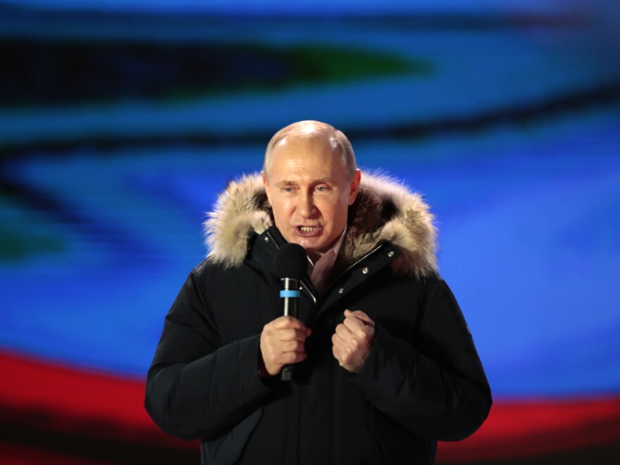 Russian President Vladimir Putin speaks during a rally near the Kremlin in Moscow, Sunday, after exit polls showed him handily winning a fourth term.