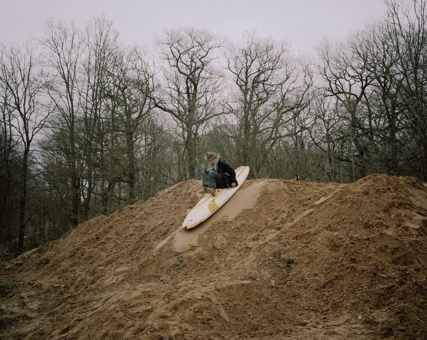 Hole surfs down a pile of mud. There is a lot of downtime between actions, and activists must find their own entertainment.