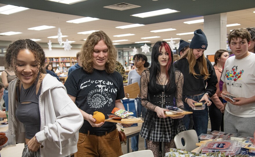 Students stand in line to grab charcuterie fixings