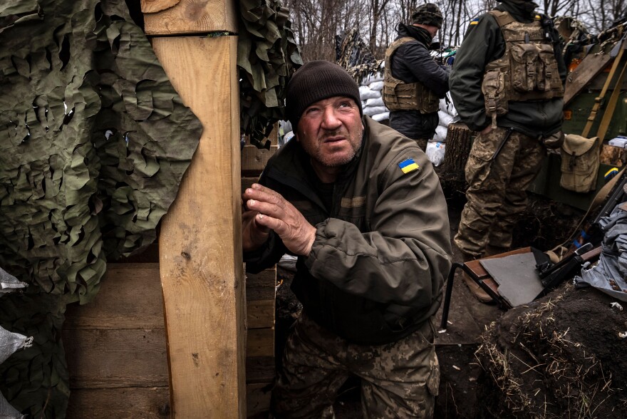 <strong>March 31:</strong> A Ukrainian serviceman looks on as he waits in a trench at the front line east of Kharkiv.