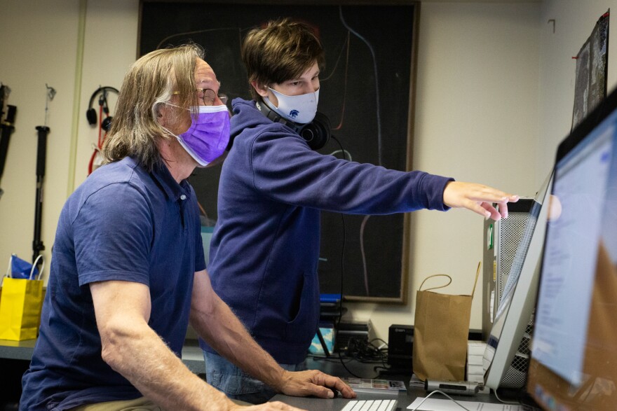 Tech coordinator, podcast and video teacher Brad Becker (left) works with eighth grader Brennan Williams in the podcast room at Sayre School in Lexington, Ky.