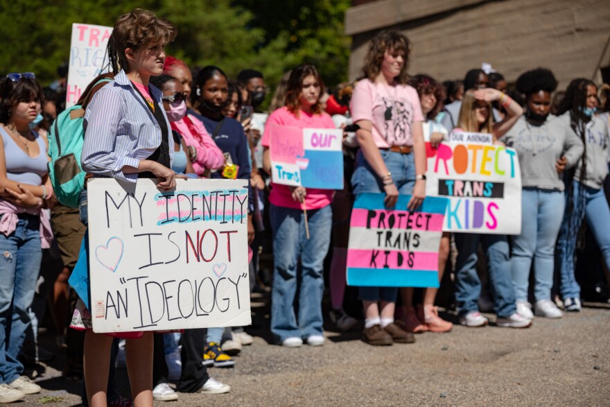 Students walk out of Richmond's Open High School in September holding signs supporting transgender students