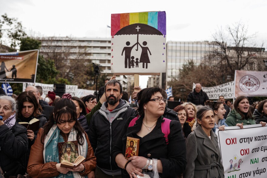 Protesters hold banners during a demonstration against the upcoming vote in parliament on the same-sex marriage bill, in Athens on Feb. 11. Greece's parliament is set to vote on legislation to legalize same-sex marriage on Thursday.