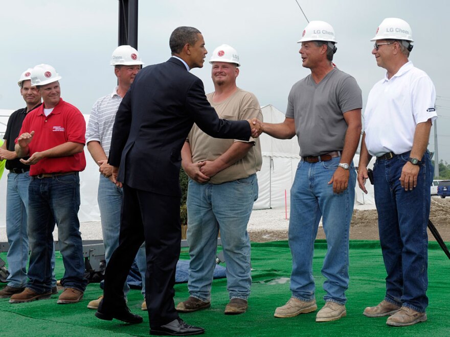 President Obama greets workers as he prepares to give a speech at the groundbreaking for a battery plant in Holland, Mich., on July 15.