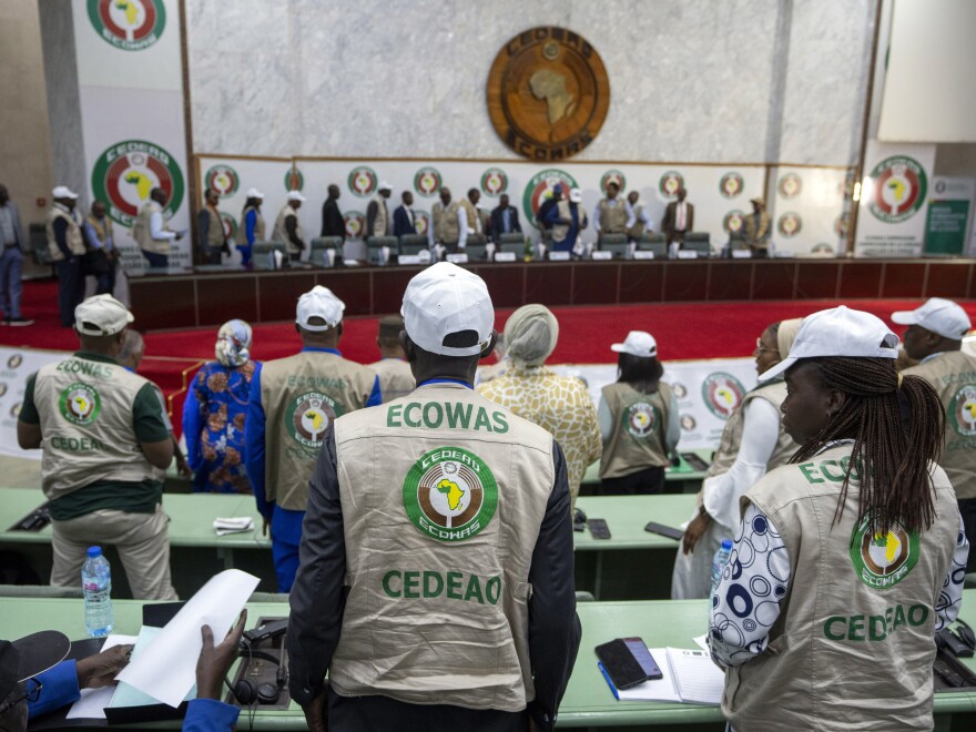 Members stand for the arrival of dignitaries at a joint press conference by African Union (AU) and Economic Community of West African States (ECOWAS) electoral observers in Abuja, Nigeria