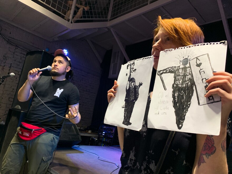 At an auction to support political prisoners in Moscow, two drawings of riot policemen go on the block. They were drawn by Oleg Navalny, the younger brother of opposition leader Alexei Navalny, who spent more than three years in prison after a conviction he calls politically motivated.
