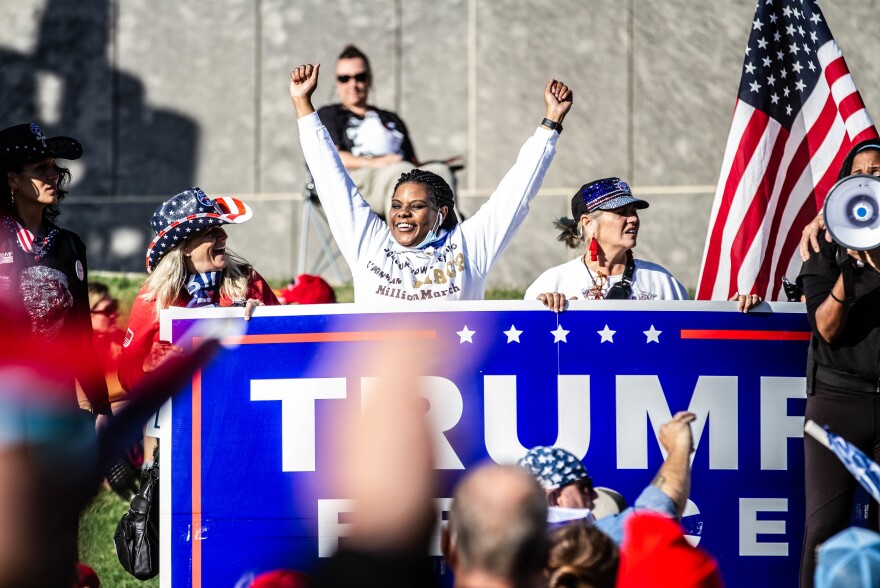 A marcher shows her support for Trump.