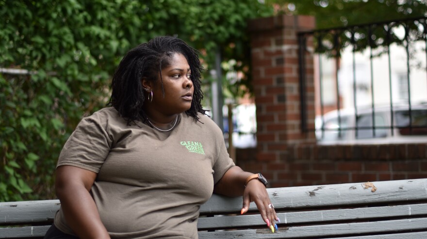 Shakira Franklin sits in a lot near her home, where she often takes breaks from her nearby job. Franklin is working to build a splash park in the lot for neighborhood residents to cool off in the summer heat.