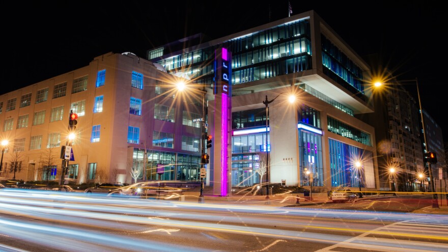 Captivating cherry blossoms adorn the enchanting night view of NPR HQ.