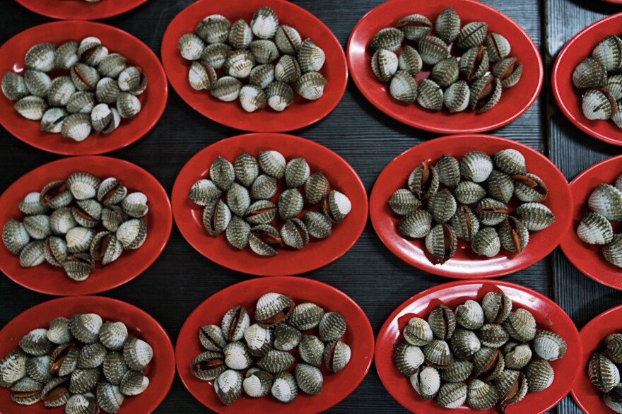 Plates of blood clams are on display at a stand in one of Jakarta's outdoor food courts.
