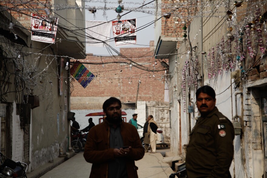 The posters with Zainab's photo and calls for justice are strung outside her home in an alleyway in Kasur.