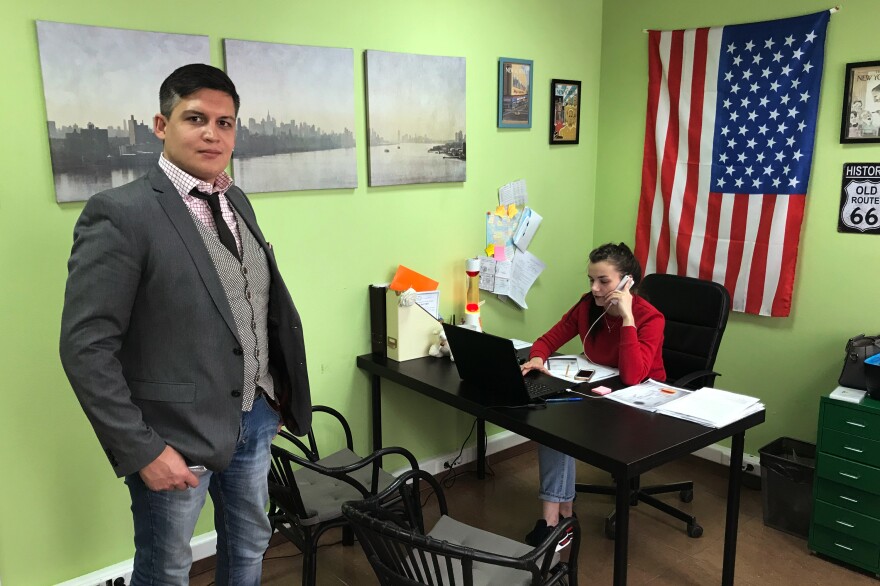Daniil Sergeyev stands in his Moscow agency that specializes in U.S. visas.